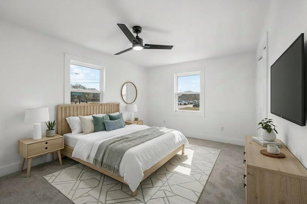 3301 Hedrick Street Fort Worth, TX 76111 - Photo 13 of 22 a bedroom with a bed and a flat screen tv