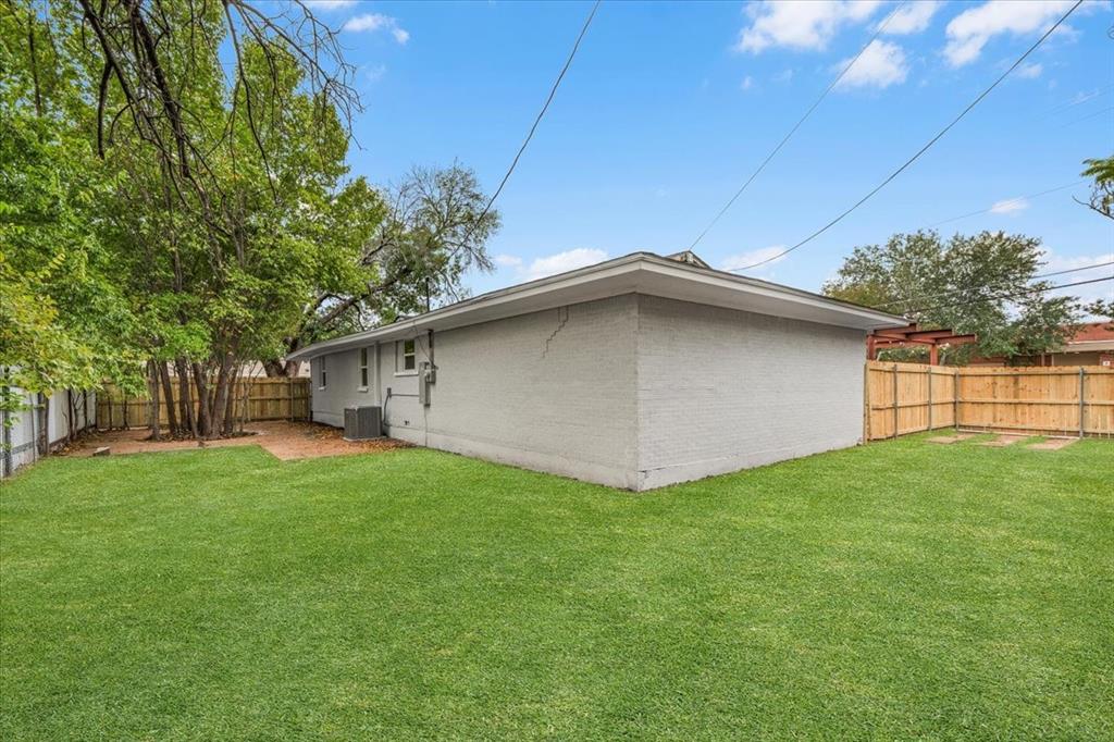 3301 Hedrick Street Fort Worth, TX 76111 - Photo 19 of 22 a view of a backyard with plants and large trees