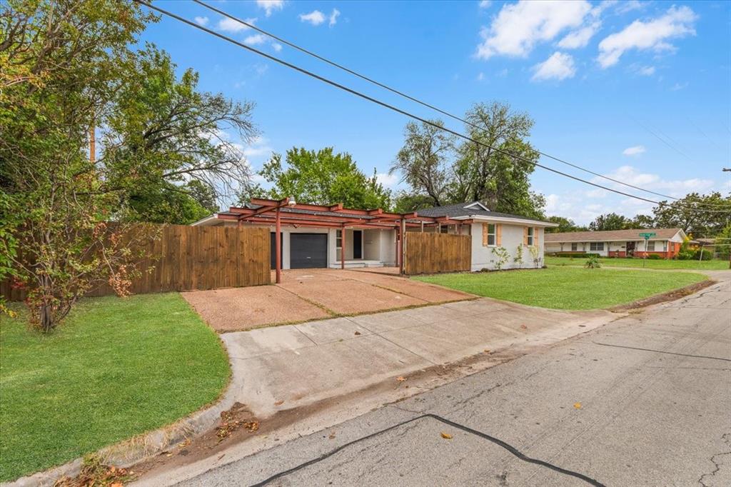 3301 Hedrick Street Fort Worth, TX 76111 - Photo 21 of 22 a front view of house with yard and green space