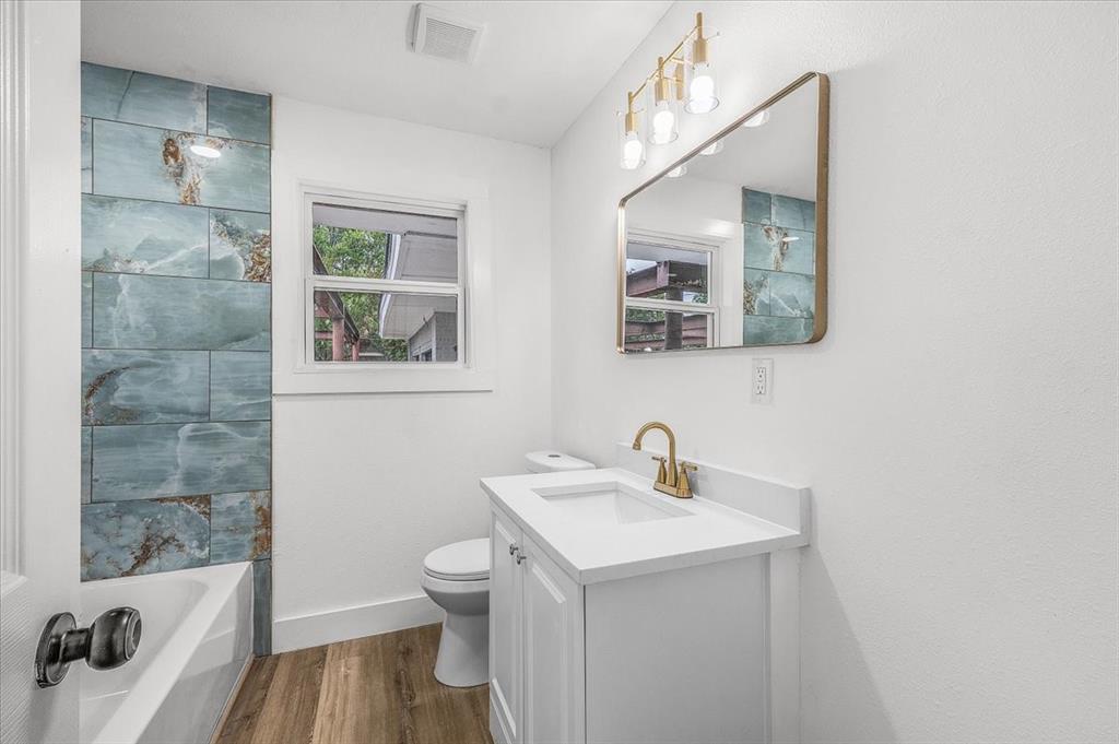 3301 Hedrick Street Fort Worth, TX 76111 - Photo 9 of 22 a bathroom with a sink a toilet and shower