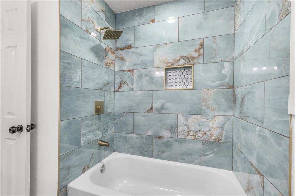 3301 Hedrick Street Fort Worth, TX 76111 - Photo 10 of 22 a bathroom with a bathtub