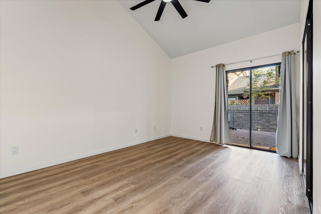 1748 Ohlen Road, Unit 75 Austin, TX 78757 - Photo 22 of 33 Empty room featuring light wood-style floors, high vaulted ceiling, and a ceiling fan