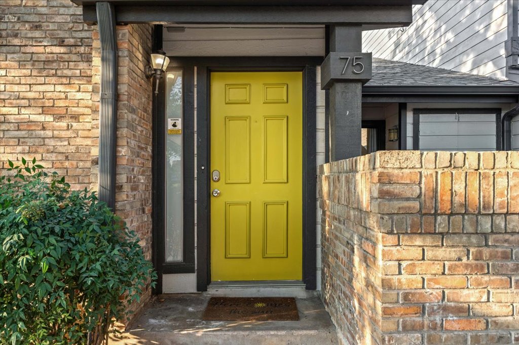 1748 Ohlen Road, Unit 75 Austin, TX 78757 - Photo 2 of 33 Doorway to property with brick siding and a shingled roof