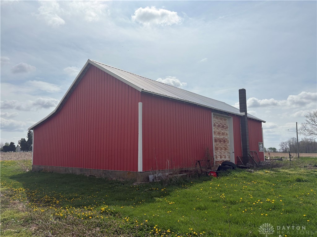 9006 Oakes Road Arcanum, OH 45304 - Photo 10 of 29 This classic red barn offers spacious storage and rustic charm amidst open fields.