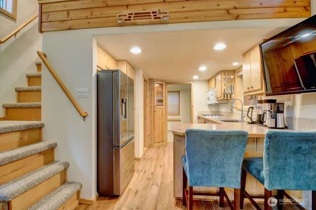 a living room with stainless steel appliances kitchen island granite countertop furniture and a kitchen view
