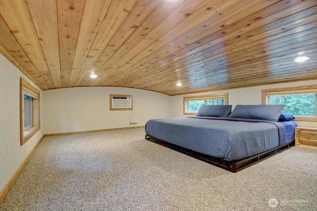 a spacious bedroom with a bed and a ceiling fan