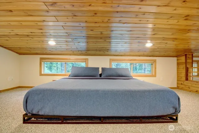 a bed sitting in a bedroom next to a window