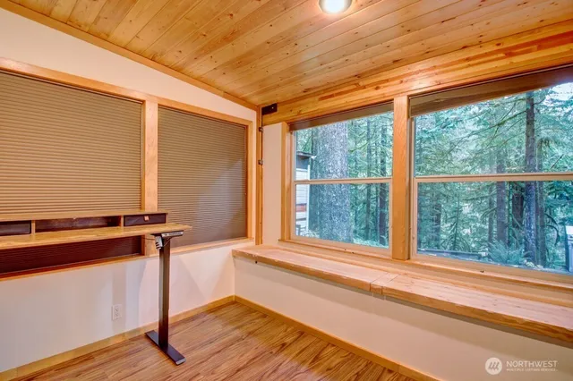 a view of a room with wooden floor and windows