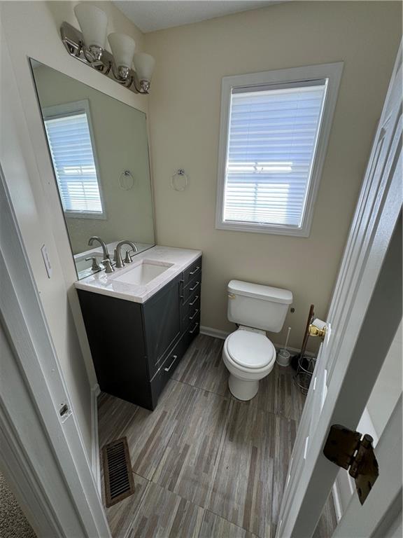 3468 Lehigh Way Decatur, GA 30034 - Photo 9 of 16 a bathroom with a toilet sink vanity granite and mirror