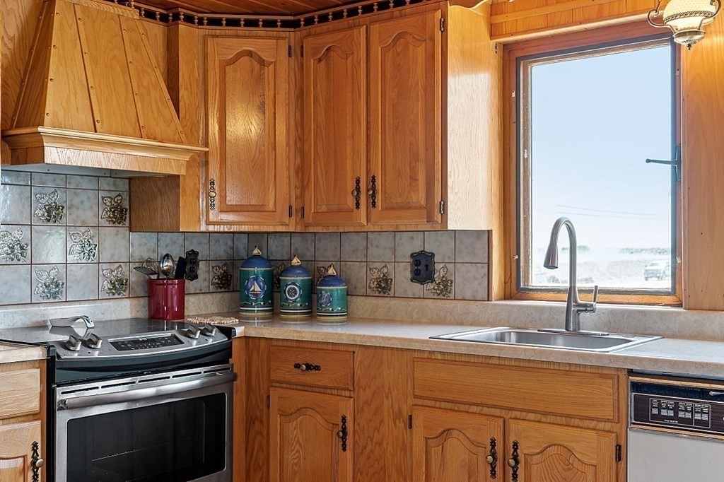 1585 Ocean Boulevard Rye, NH 03870 - Photo 20 of 41 a kitchen with granite countertop a sink stainless steel appliances and cabinets