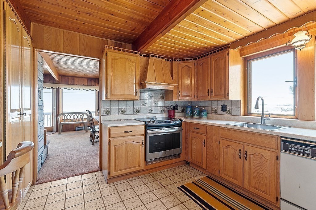 1585 Ocean Boulevard Rye, NH 03870 - Photo 21 of 41 a kitchen with stainless steel appliances granite countertop a stove a sink and a refrigerator