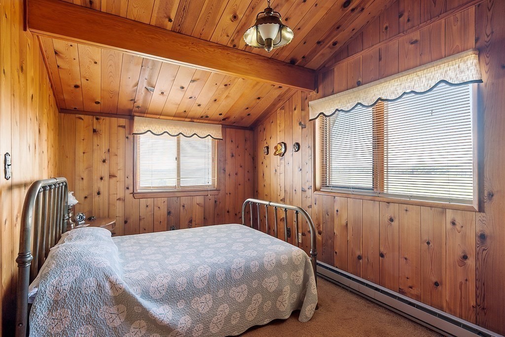 1585 Ocean Boulevard Rye, NH 03870 - Photo 38 of 41 a bedroom with a bed and wooden floor