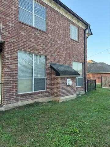 a brick house with a small yard