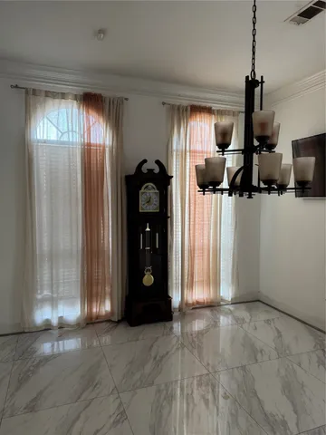 a view of empty room with windows and fan