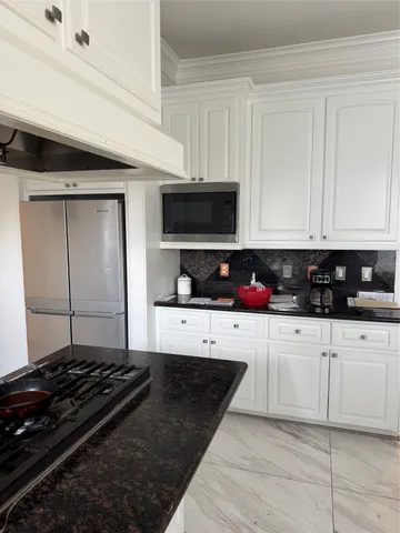 a kitchen with stainless steel appliances granite countertop a stove and a granite counter tops