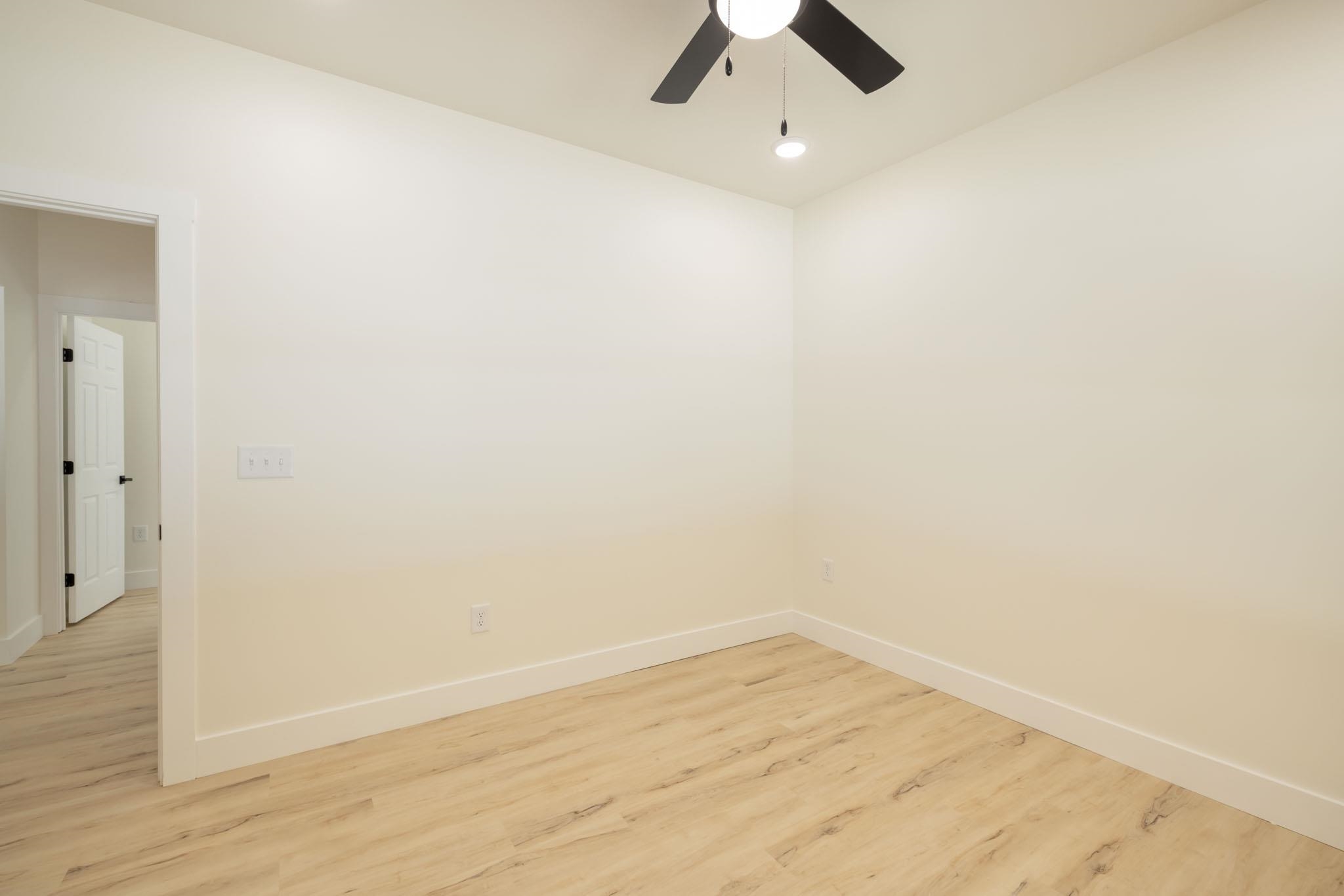 37 William Teague Lane Ramer, TN 38367 - Photo 33 of 39 Room featuring wood-finish flooring, white baseboards, and neutral wall paint