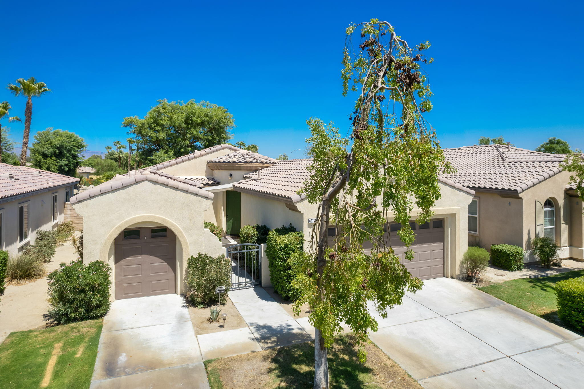 49728 Pacino Street Indio, CA 92201 - Photo 1 of 54 a front view of a house with a garden
