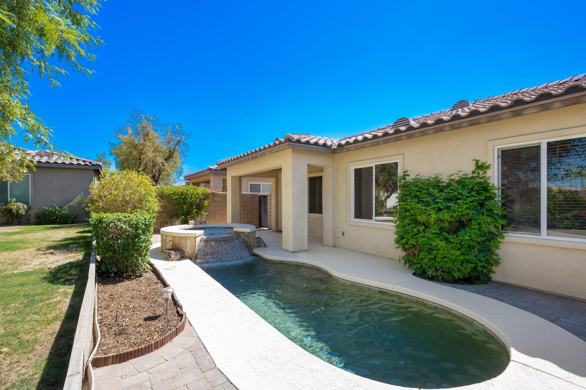 49728 Pacino Street Indio, CA 92201 - Photo 41 of 54 a view of a house with backyard and garden