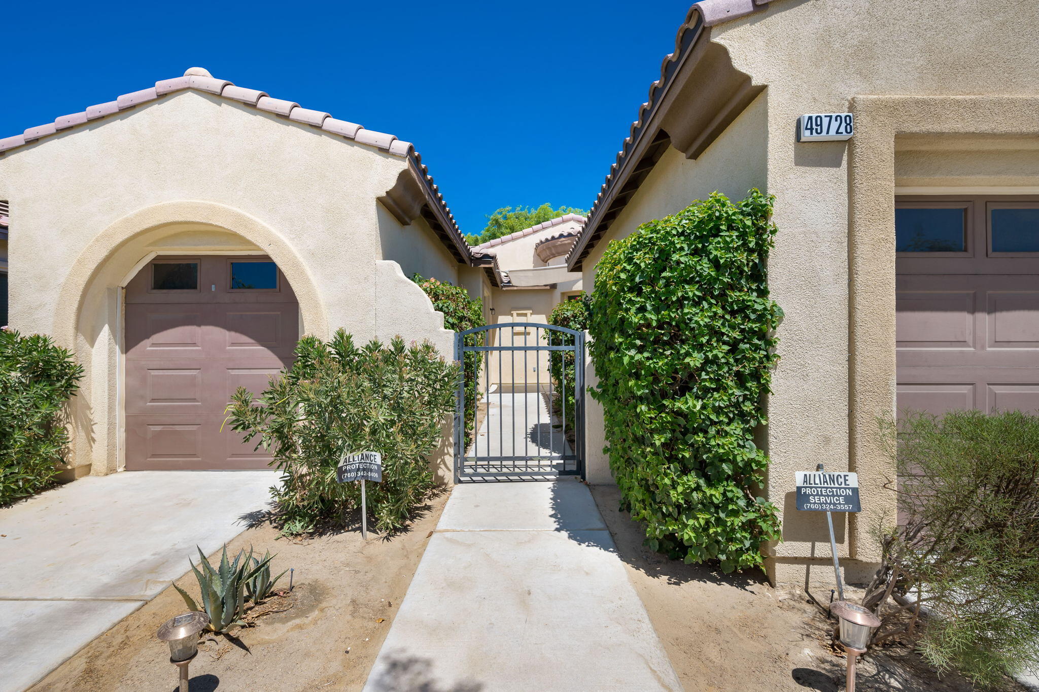 49728 Pacino Street Indio, CA 92201 - Photo 7 of 54 a view of a white house with a yard and plants
