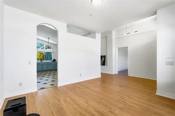a view of a bedroom with wooden floor and cabinet