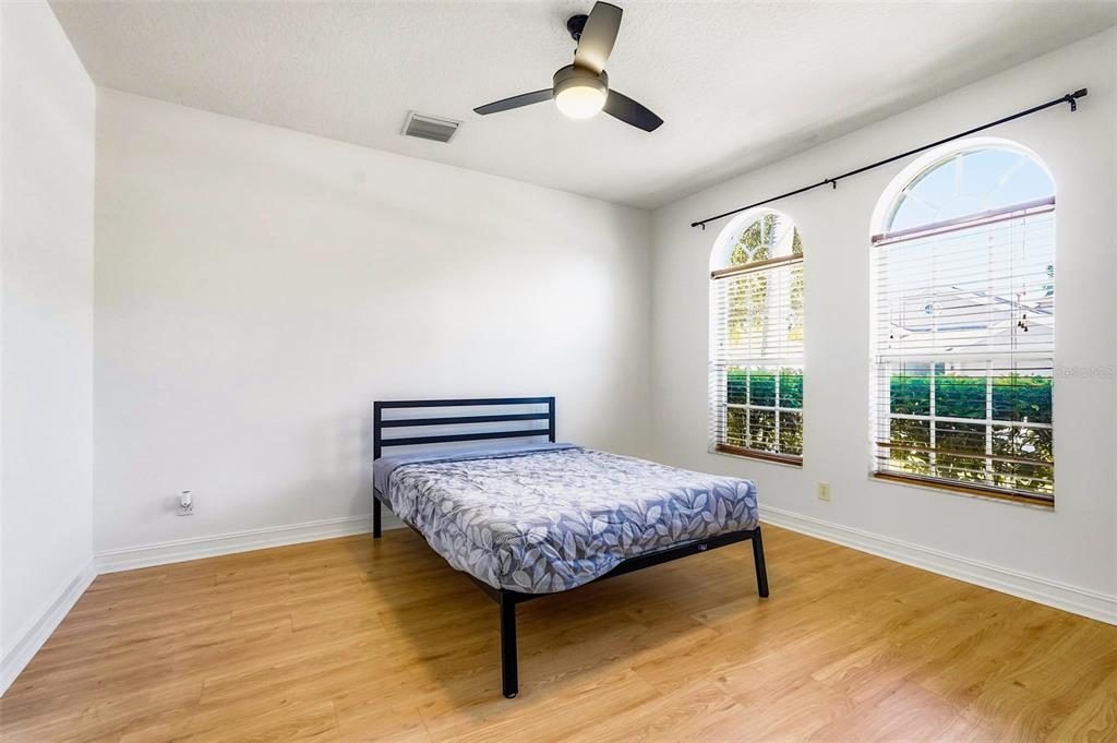 2807 Manning Drive Trinity, FL 34655 - Photo 16 of 48 a bedroom with a bed and wooden floor