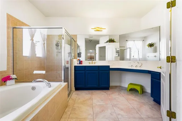 a bathroom with a tub a sink and a mirror