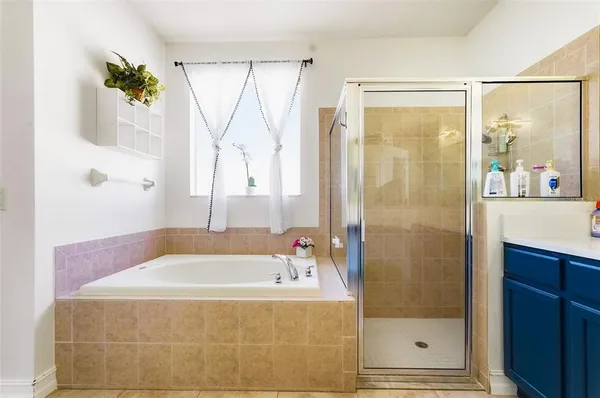 a bathroom with a tub and shower