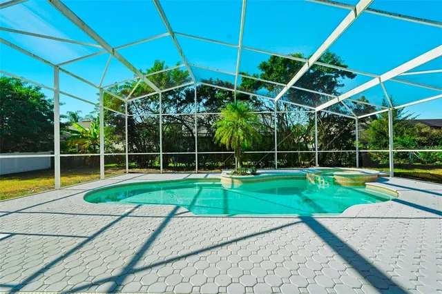 a view of a backyard with swimming pool