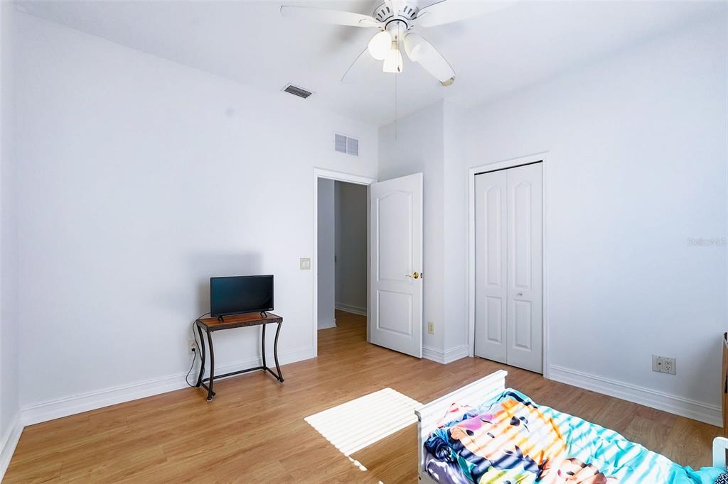 2807 Manning Drive Trinity, FL 34655 - Photo 26 of 48 a bedroom with a bed and a table in it