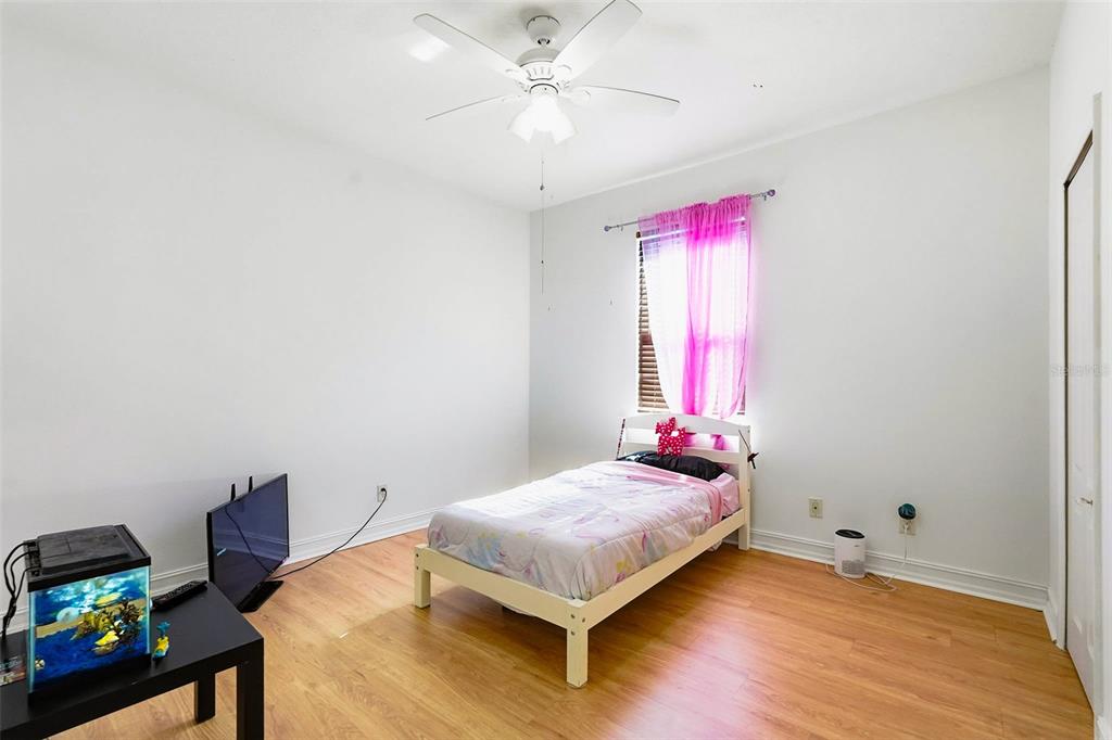 2807 Manning Drive Trinity, FL 34655 - Photo 27 of 48 a bedroom with a bed and a chandelier