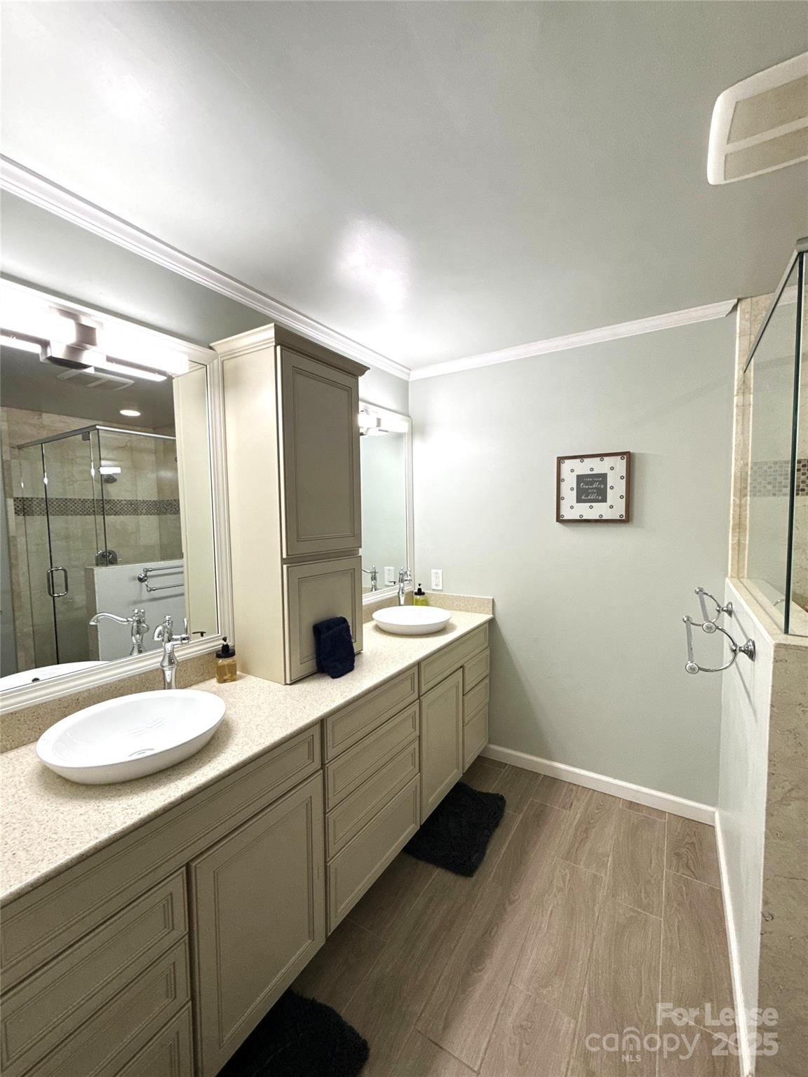 1600 Paddock Circle Charlotte, NC 28209 - Photo 17 of 34 a bathroom with a double vanity sink a mirror and a bathtub