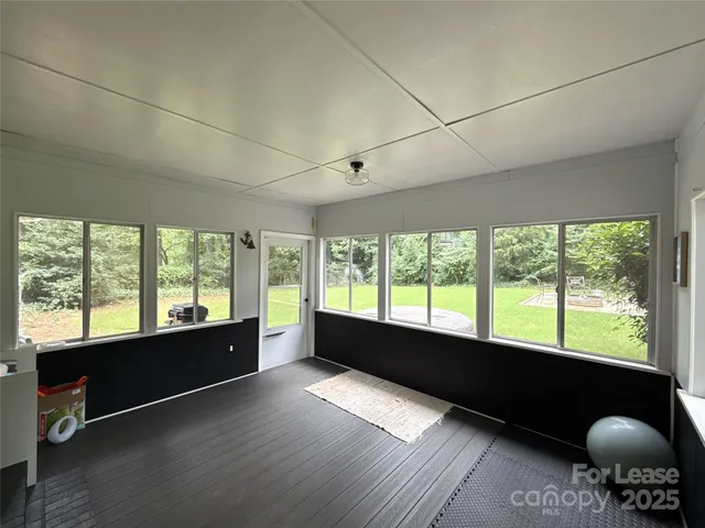 a room with wooden floor and furniture