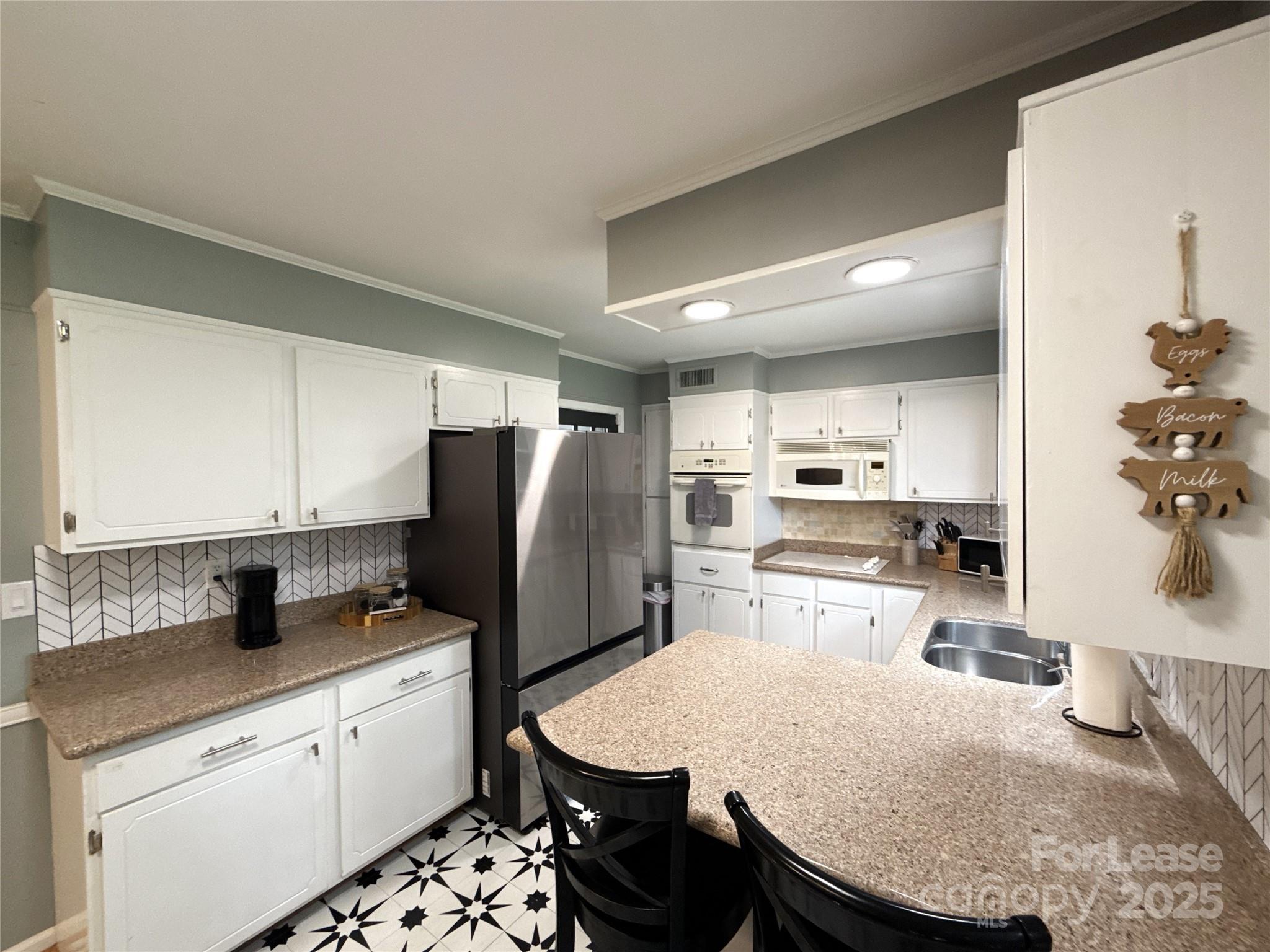 1600 Paddock Circle Charlotte, NC 28209 - Photo 7 of 34 a kitchen with refrigerator and wooden cabinets