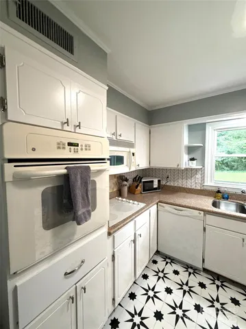 a kitchen with appliances cabinets and a sink