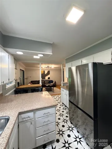 a kitchen with a refrigerator and a sink