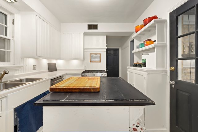 3022 Thayer Street Evanston, IL 60201 - Photo 12 of 23 a kitchen with stainless steel appliances granite countertop a sink and dishwasher with wooden floor