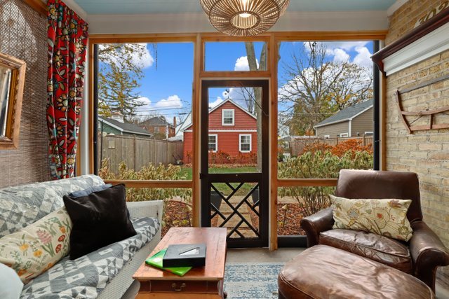 3022 Thayer Street Evanston, IL 60201 - Photo 16 of 23 a living room with furniture and a floor to ceiling window