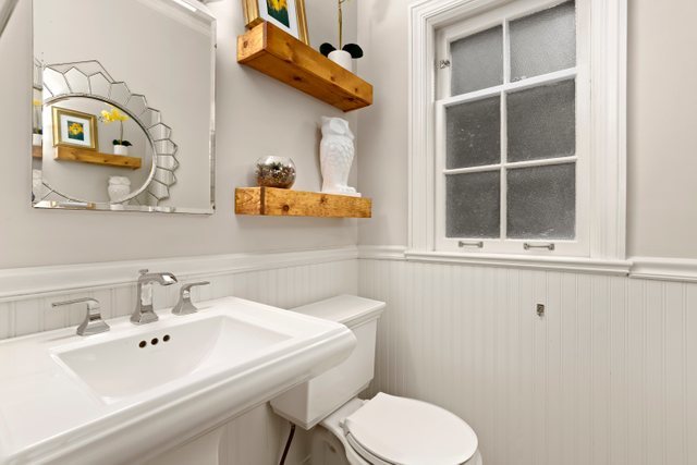 3022 Thayer Street Evanston, IL 60201 - Photo 18 of 23 a bathroom with a toilet sink and mirror
