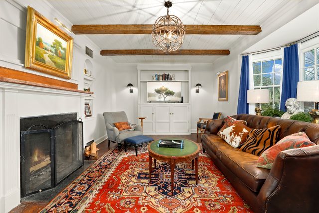 3022 Thayer Street Evanston, IL 60201 - Photo 4 of 23 a living room with furniture a chandelier and a fireplace