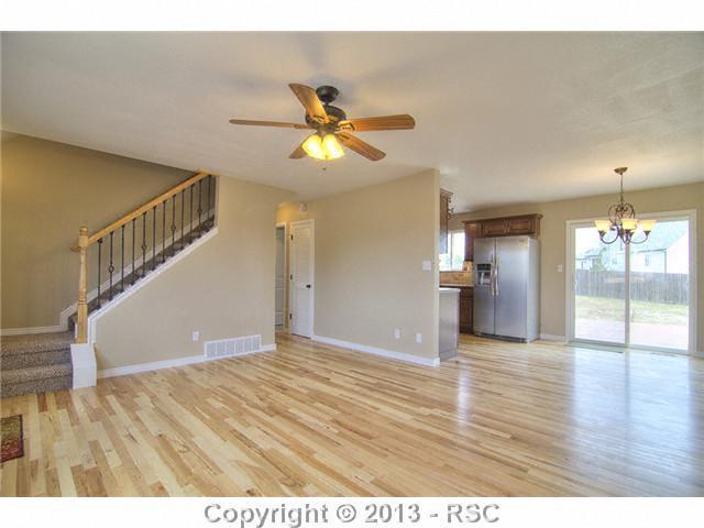 10865 Falling Star Road Fountain, CO 80817 - Photo 2 of 23 Exquisite hardwood flooring throughout living room, dining room & kitchen.