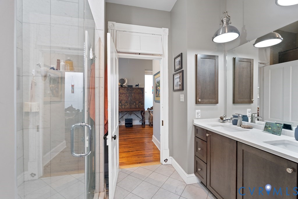 215 West 3rd Street Farmville, VA 23901 - Photo 19 of 52 a bathroom with a double vanity sink shower and a mirror