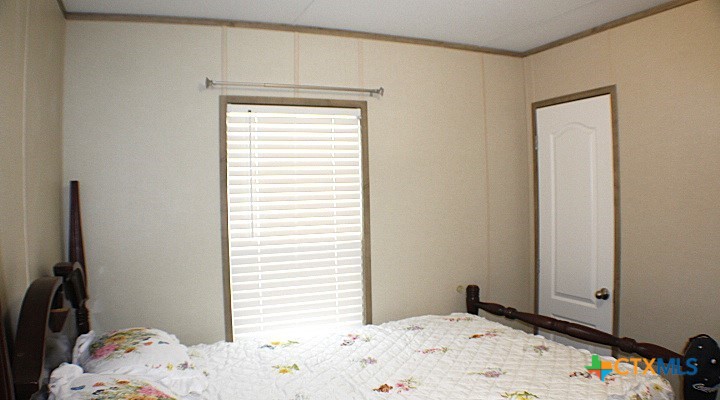 12240 Fm 1383 Schulenburg, TX 78956 - Photo 13 of 24 a bedroom with a bed and a window