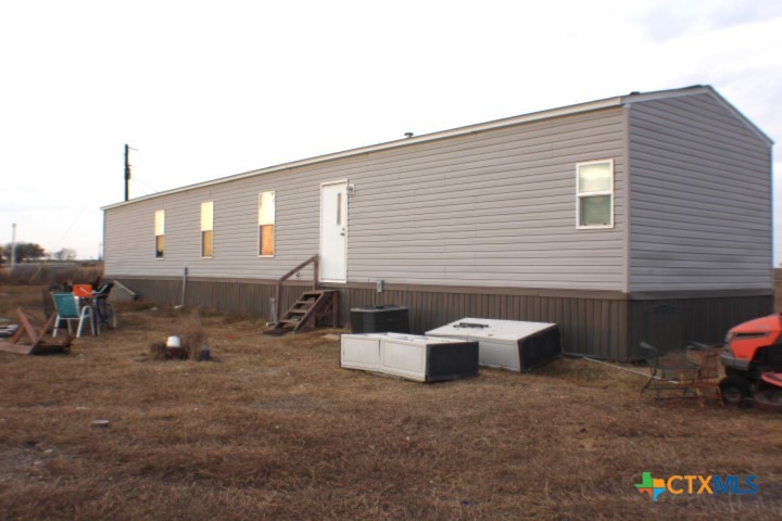 12240 Fm 1383 Schulenburg, TX 78956 - Photo 2 of 24 a backyard of a house with sofas fire pit and outdoor seating