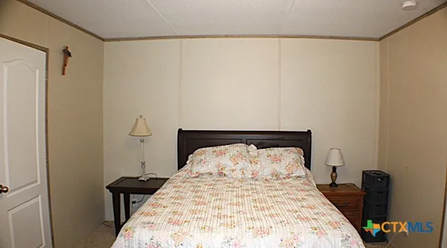 a bedroom with a bed and a television