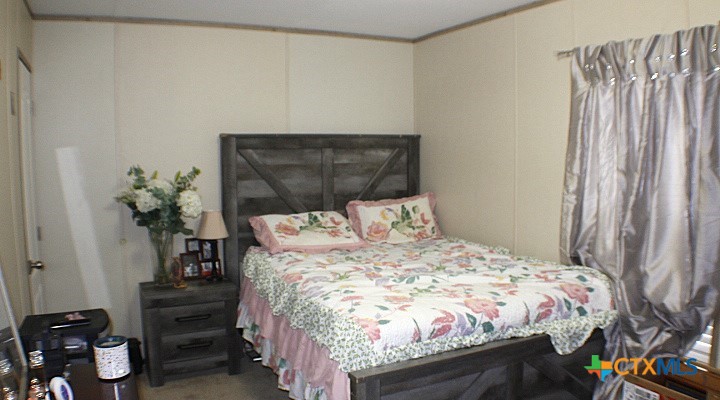 12240 Fm 1383 Schulenburg, TX 78956 - Photo 9 of 24 a bed sitting in a bedroom next to a window
