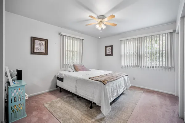 a bedroom with a bed and a flat tv screen