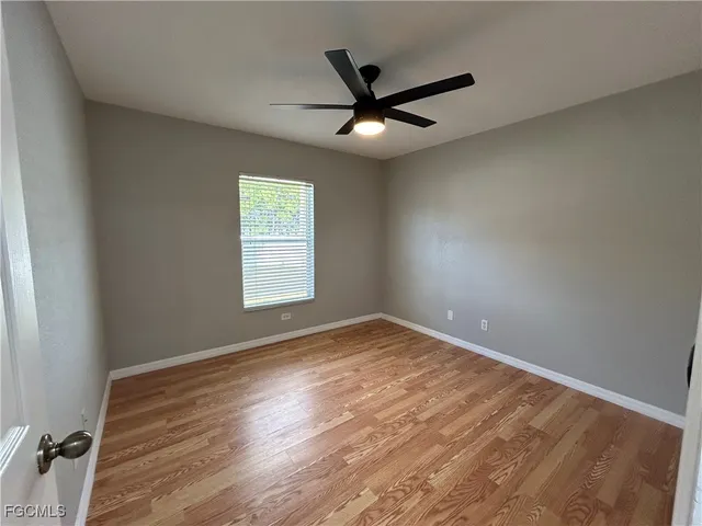 wooden floor in an empty room with a window