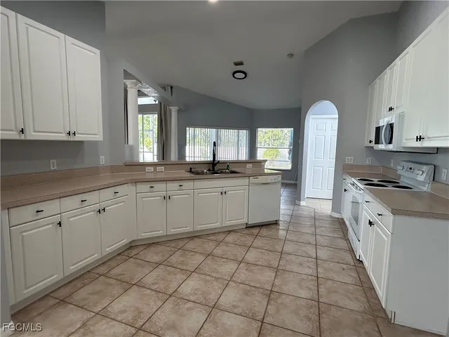 a kitchen with a sink stove and cabinets