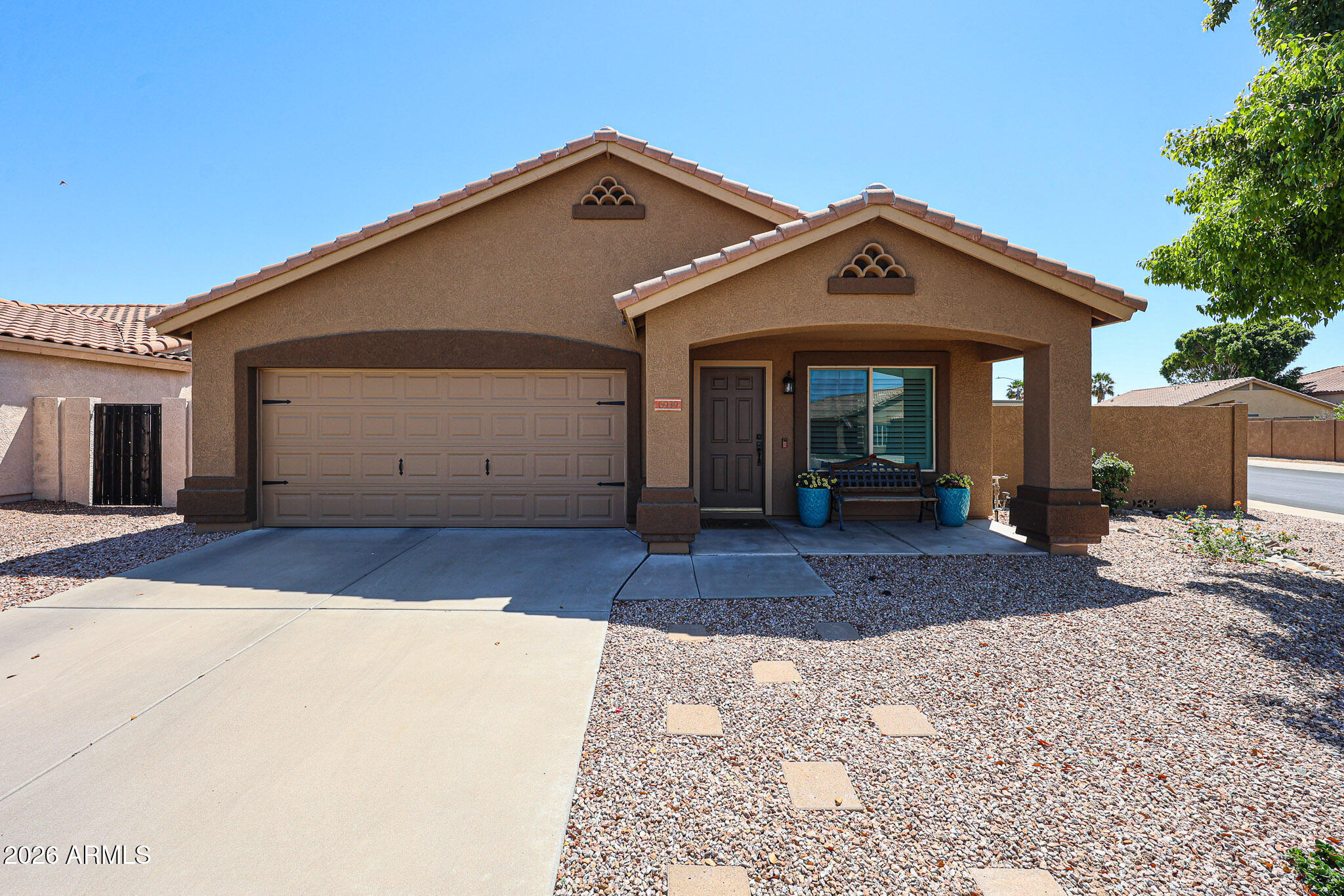 6939 West Phelps Road Peoria, AZ 85382 - Photo 1 of 29 a front view of a house with a yard