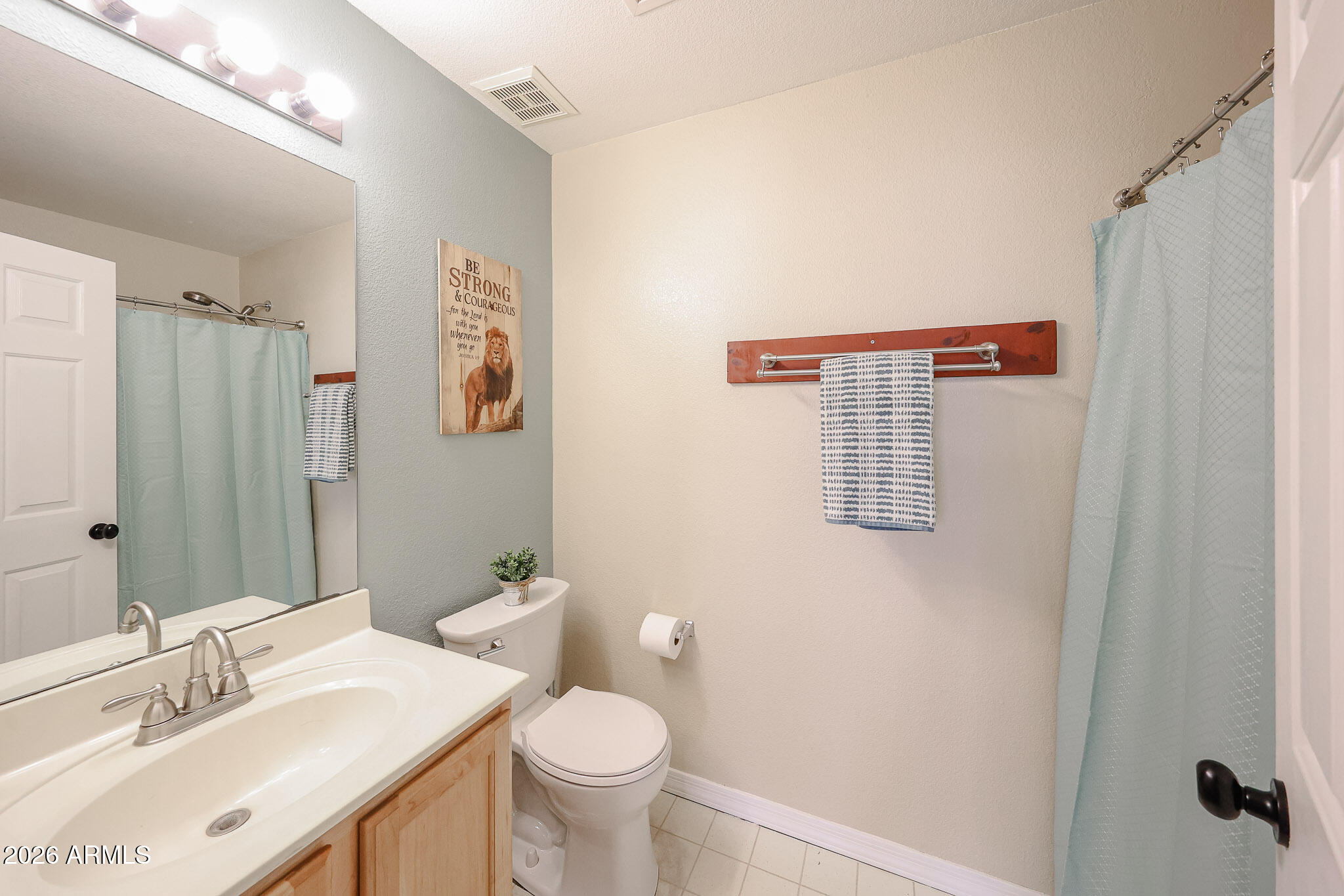 6939 West Phelps Road Peoria, AZ 85382 - Photo 17 of 29 a bathroom with a sink toilet and shower